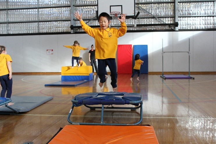 Child jumping off trampoline